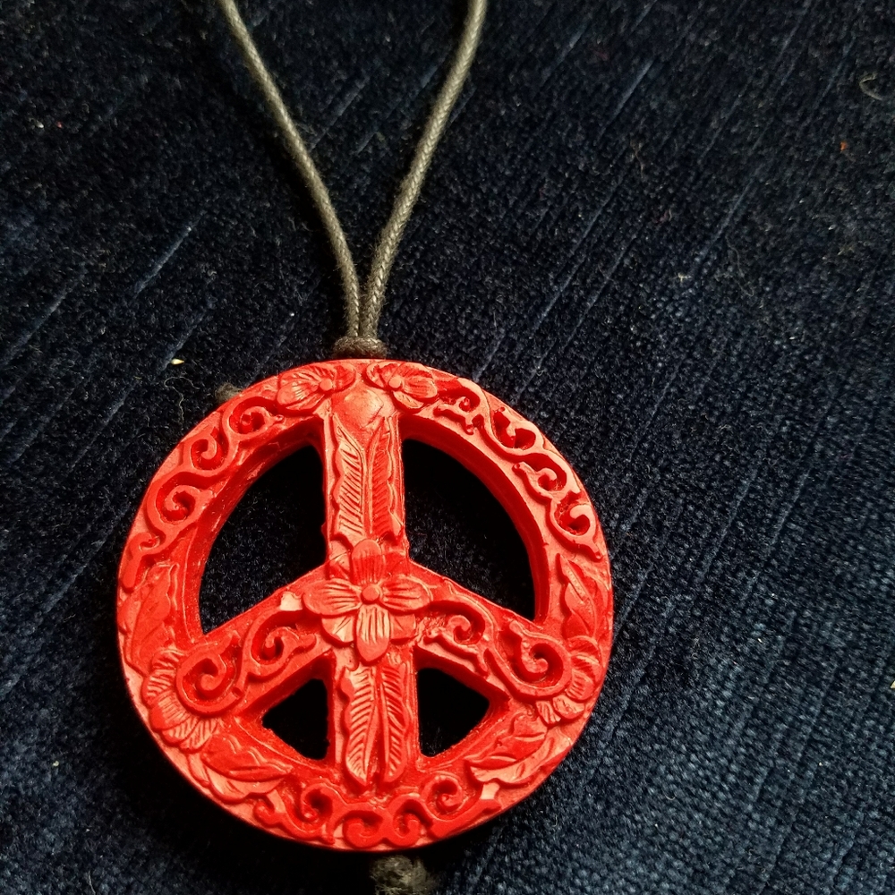 red encarved peace necklace